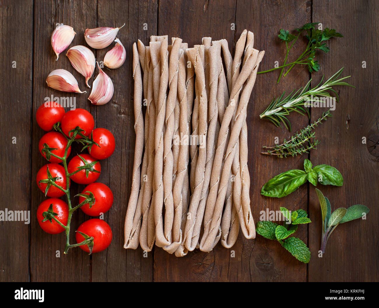 Raw italian  pasta, herbs and vegetables Stock Photo