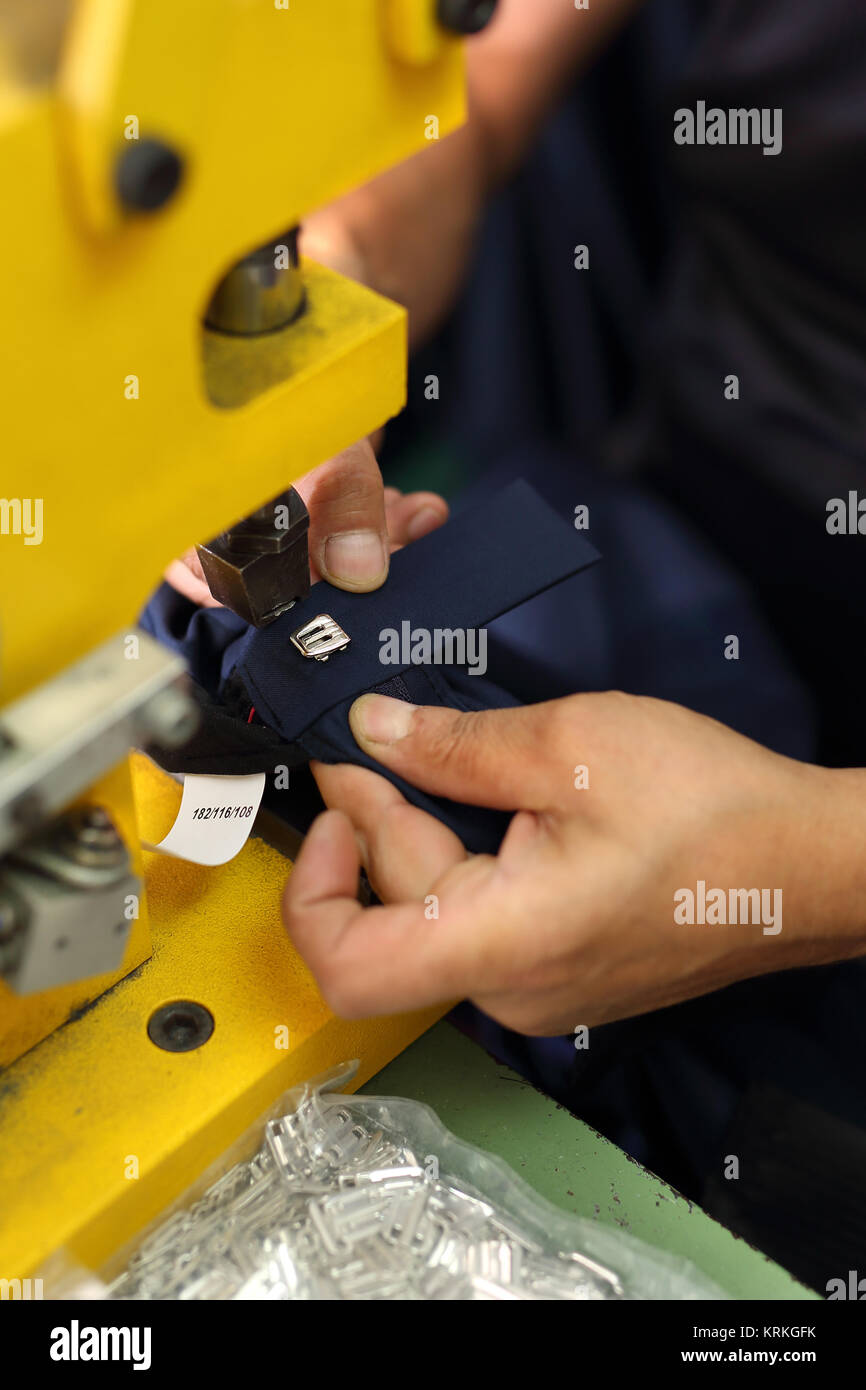 seamstress sewing on buttons trouser Stock Photo - Alamy