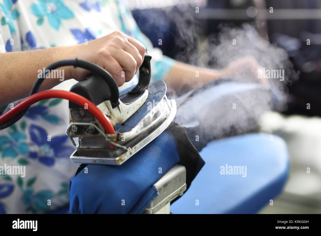 clothing industry. ironing steam. presser in sewing clothes pressed