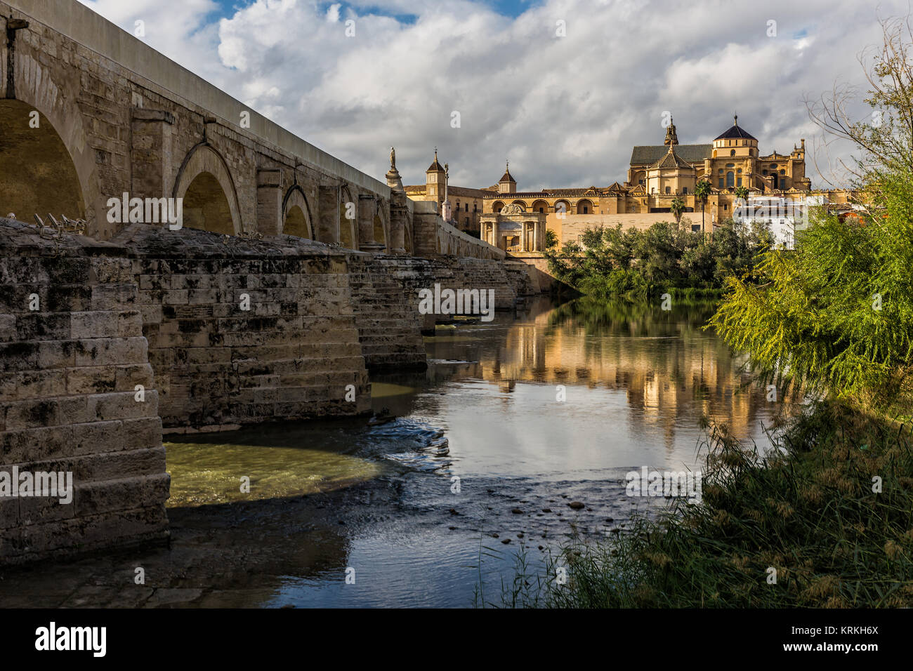 In the foreground the Guadalquivir river, with the Roman Bridge. In background the Mosque-Cathedral. Cordoba. Spain. Stock Photo