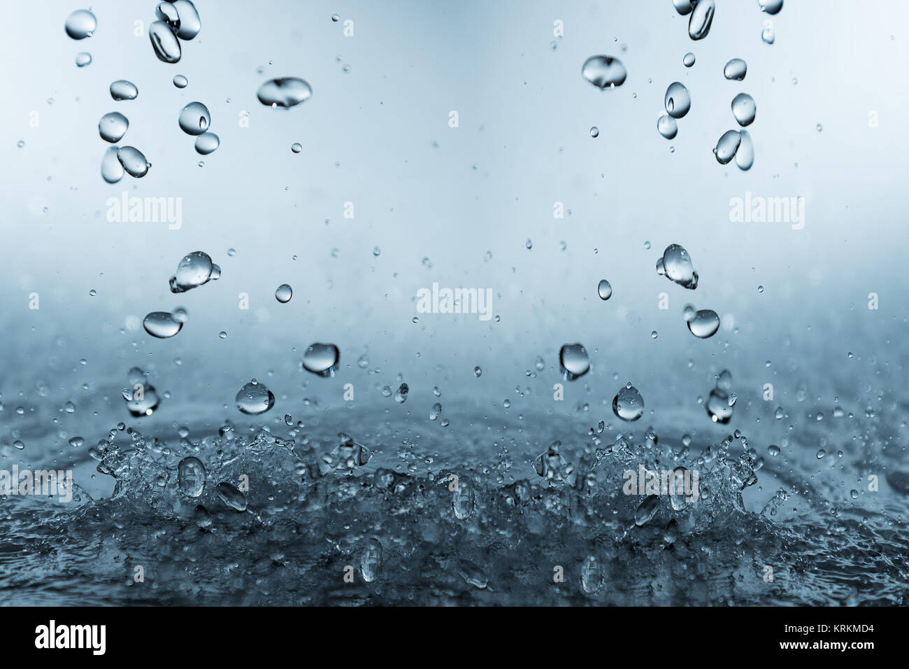 Falling and splashing water drops Stock Photo - Alamy