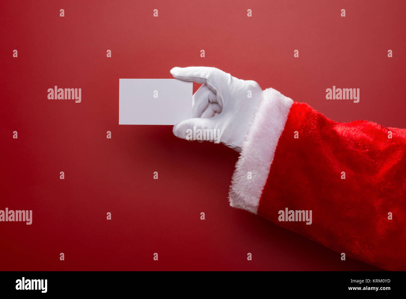 Santa Claus holding a white blank card good for test on red background ...