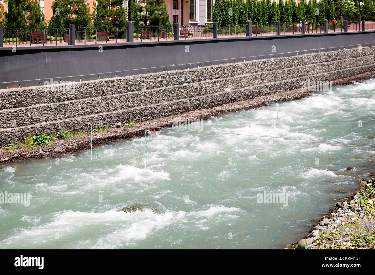 Mountain river flowing along the embankment. Stock Photo