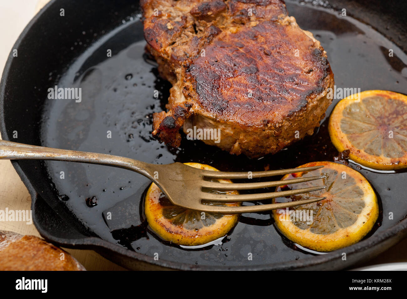pork chop seared on iron skillet Stock Photo Alamy