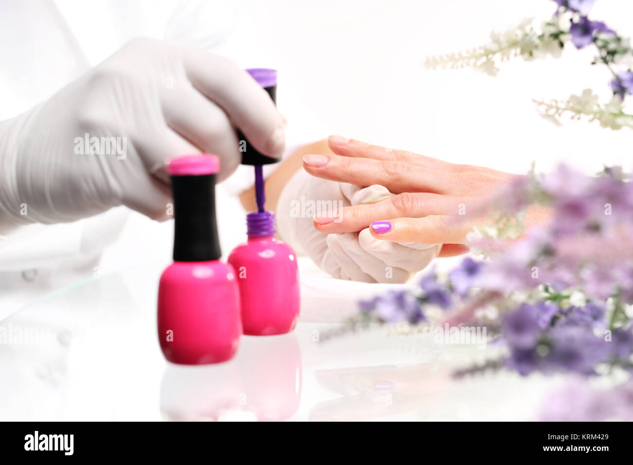 colored manicure,beautician painting nails colored lacquer Stock Photo