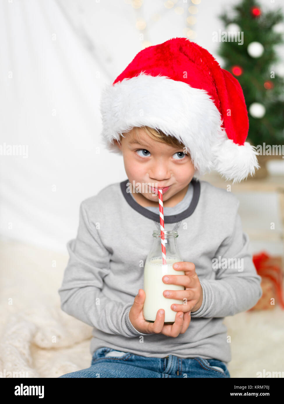 young drinking milk and has weihnachtsmÃ¼tze on Stock Photo
