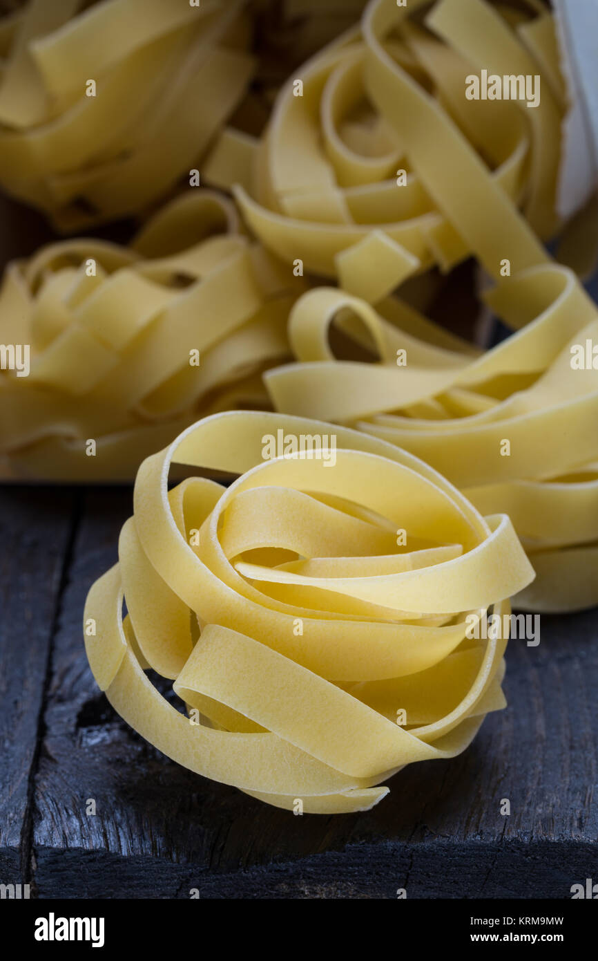 Fettuccine noodle on dark rustic wood Stock Photo Alamy