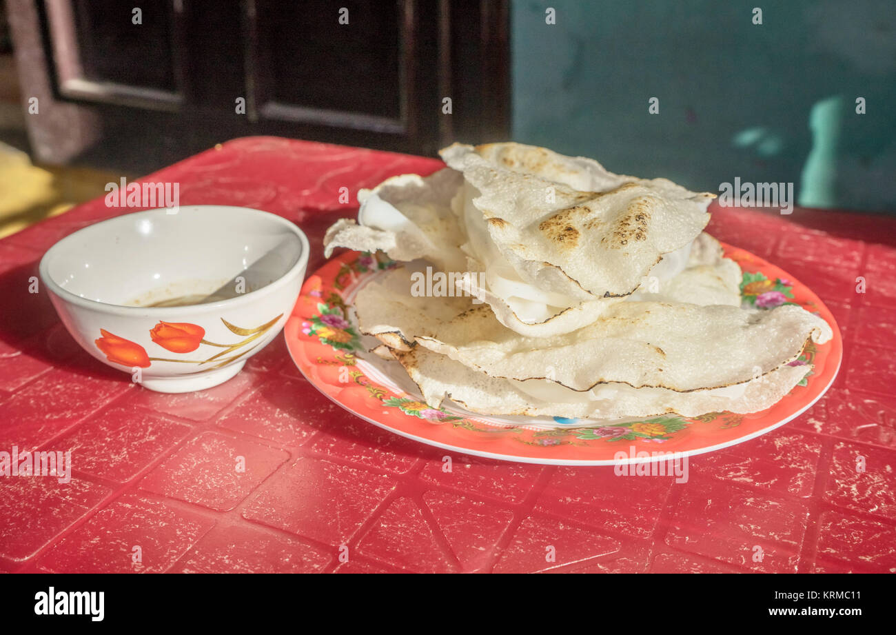 Smashing rice paper or Banh Dap, traditional Vietnamese food of Hoi An Stock Photo