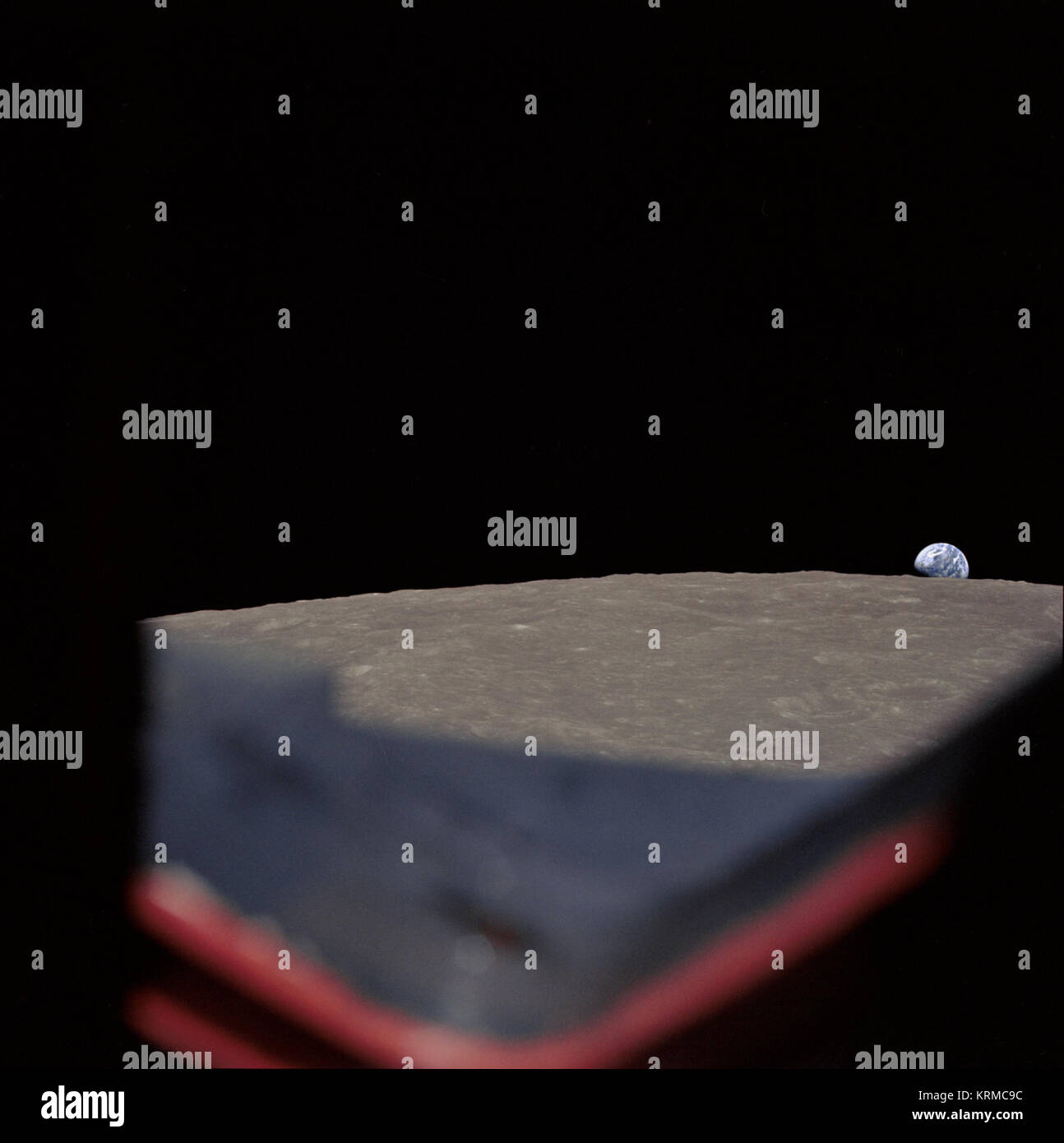 Earth rising above the lunar horizon Stock Photo