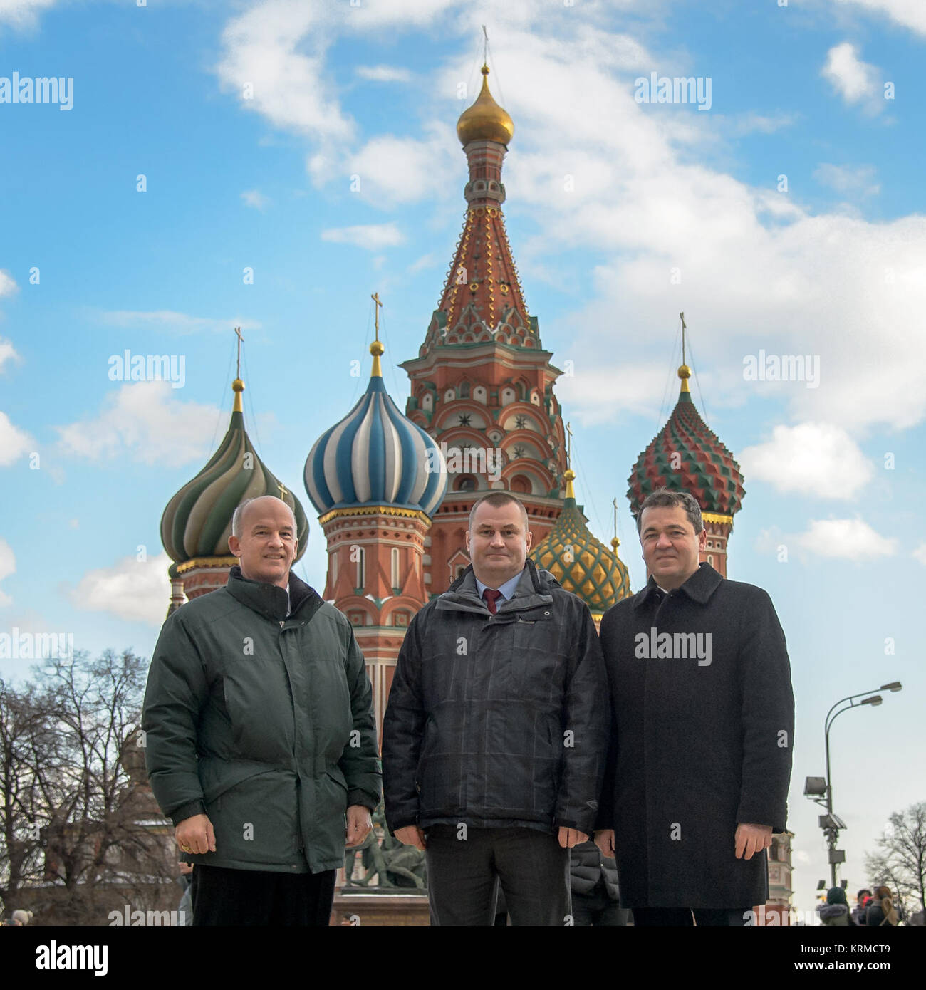 Expedition 47 crew members: NASA astronaut Jeff Williams, left, Russian cosmonauts Alexei Ovchinin, center, and Oleg Skripochka of Roscosmos, pose for a photograph in front of Saint Basil's Cathedral in Red Square shortly after having laid roses at the site where Russian space icons are interred as part of traditional pre-launch ceremonies Friday, Feb. 26, 2016, Moscow, Russia. Photo Credit: (NASA/Bill Ingalls) Expedition 47 Preflight (NHQ201602260001) Stock Photo