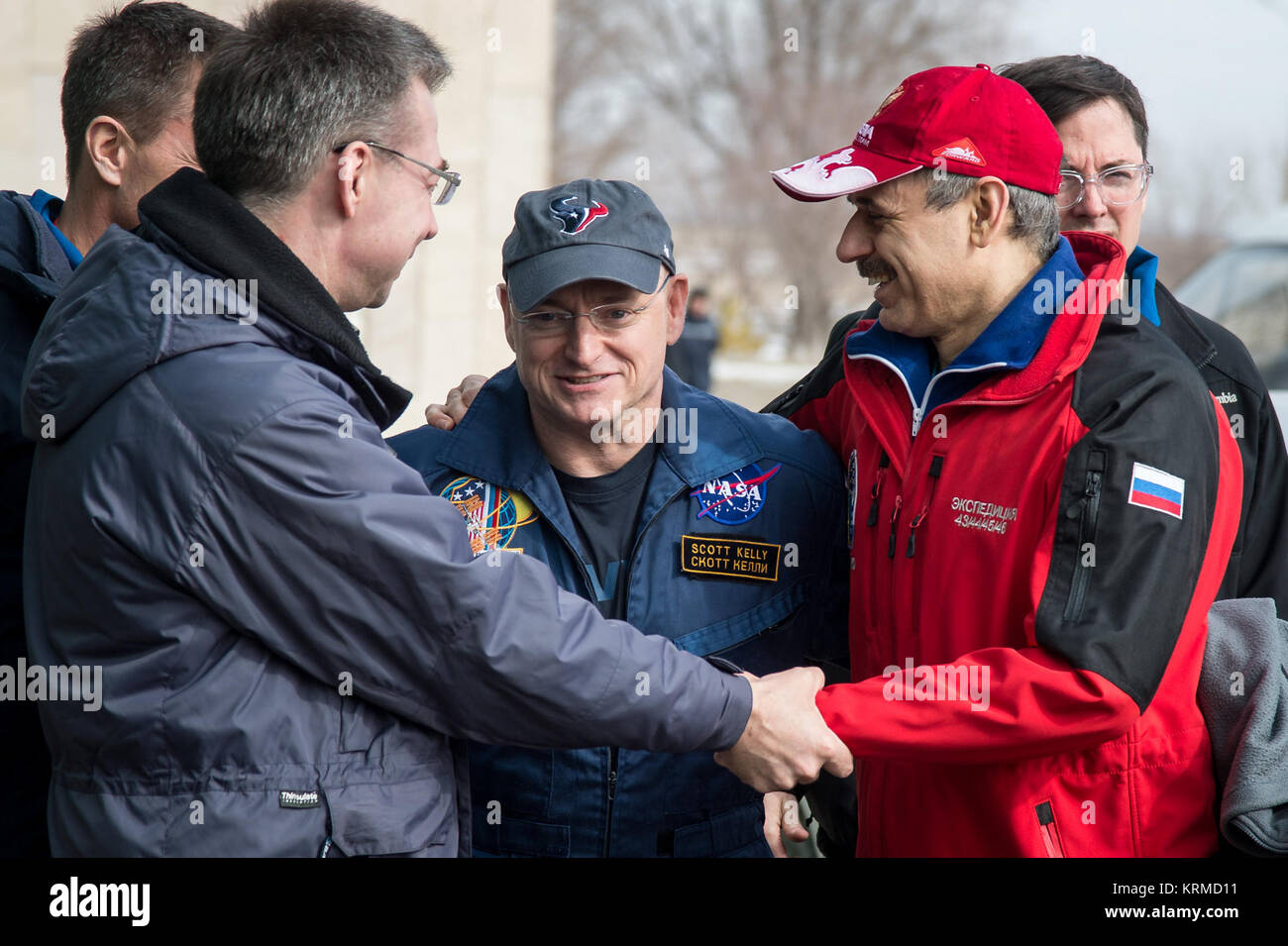 Expedition 46 Commander Scott Kelly of NASA, center, is embraced by Russian cosmonaut Mikhail Kornienko of Roscosmos, right, after the two arrived at the Zhezkazgan Airport in separate helicopters from the Soyuz TMA-18M spacecraft landing site on Wednesday, March 2, 2016 (Kazakh time). Kelly and Kornienko completed an International Space Station record year-long mission to collect valuable data on the effect of long duration weightlessness on the human body that will be used to formulate a human mission to Mars. Russian cosmonaut Sergey Volkov of Roscosmos returned after spending six months on Stock Photo