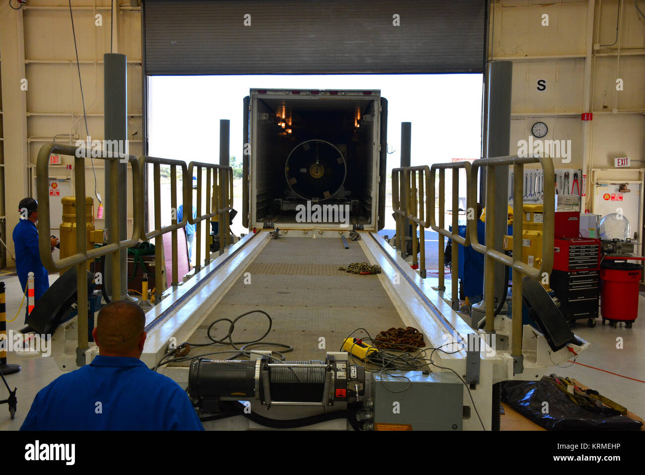 Inside Building 1555 at Vandenberg Air Force Base in California, technicians and engineers offload the first stage motor for the Orbital ATK Pegasus XL rocket which will launch eight NASA Cyclone Global Navigation Satellite System, or CYGNSS, spacecraft. When preparations are completed at Vandenberg, the rocket, with CYGNSS in its payload fairing, will be attached to the Orbital ATK L-1011 carrier aircraft and transported to NASA’s Kennedy Space Center in Florida. On Dec. 12, 2016, the carrier aircraft is scheduled to take off from the Skid Strip at Cape Canaveral Air Force Station and CYGNSS  Stock Photo