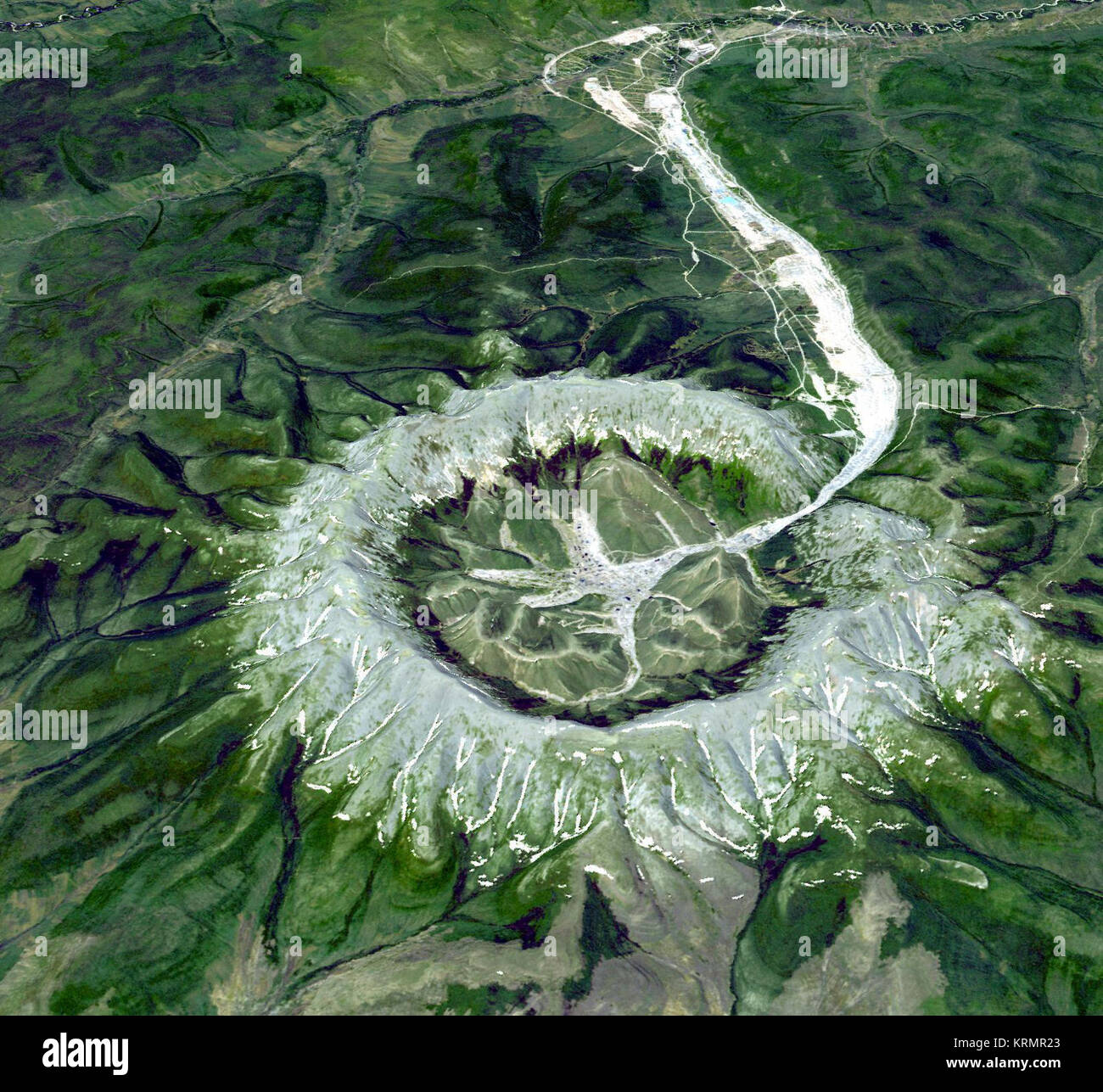 Kondyor Massif, Russia   This is neither an impact crater nor a volcano. It is a perfect circular intrusion, about 10 km in diameter with a topographic ridge up to 600 m high. The Kondyor Massif is located in Eastern Siberia, Russia, north of the city of Khabarovsk. It is a rare form of igneous intrusion called alkaline-ultrabasic massif and it is full of rare minerals. The river flowing out of it forms placer mineral deposits. Last year 4 tons of platinum were mined there. A remarkable and very unusual mineralogical feature of the deposit is the presence of coarse crystals of Pt-Fe alloy, coa Stock Photo