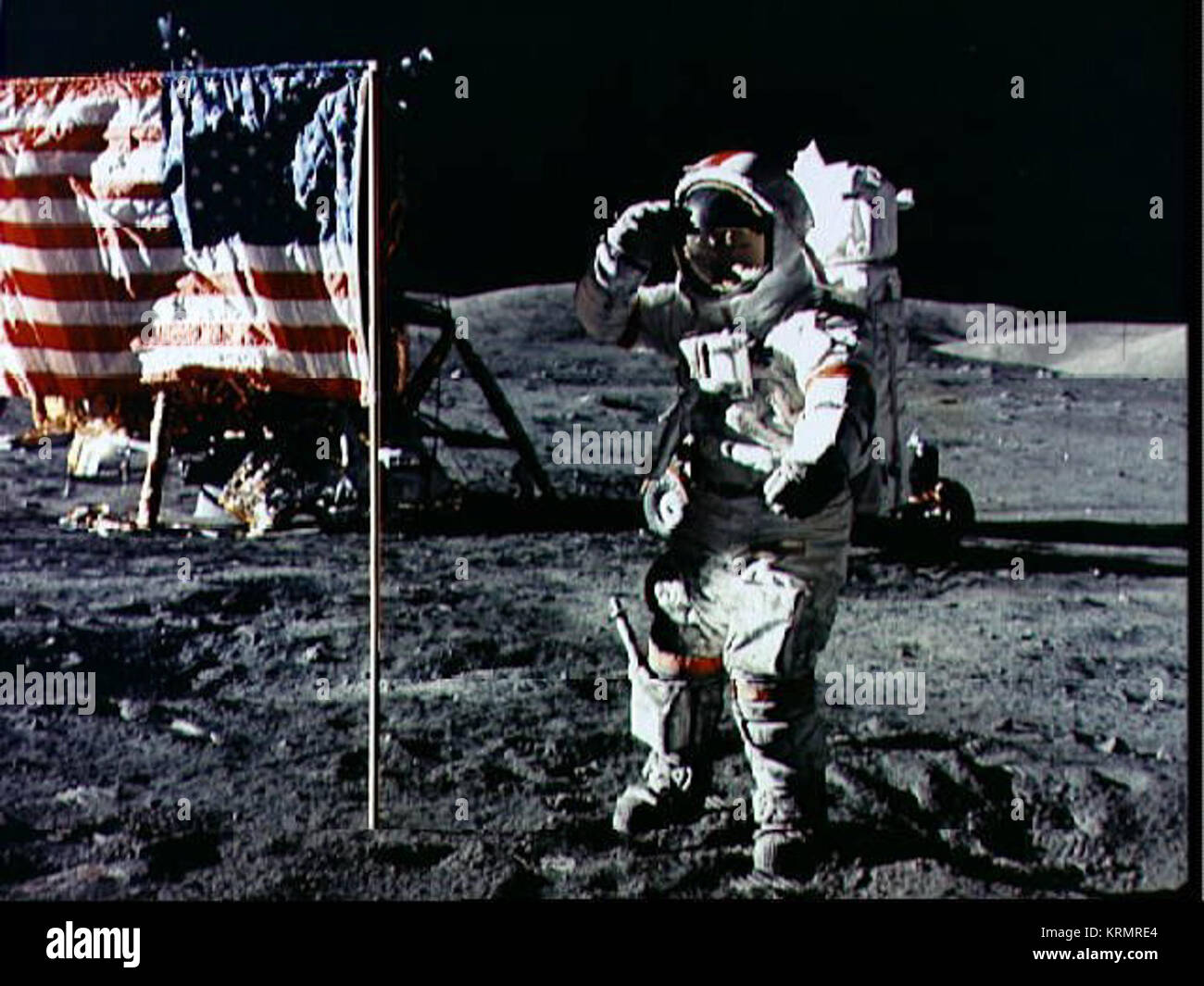 Astronaut Eugene A. Cernan, Apollo 17 commander, salutes the deployed U ...