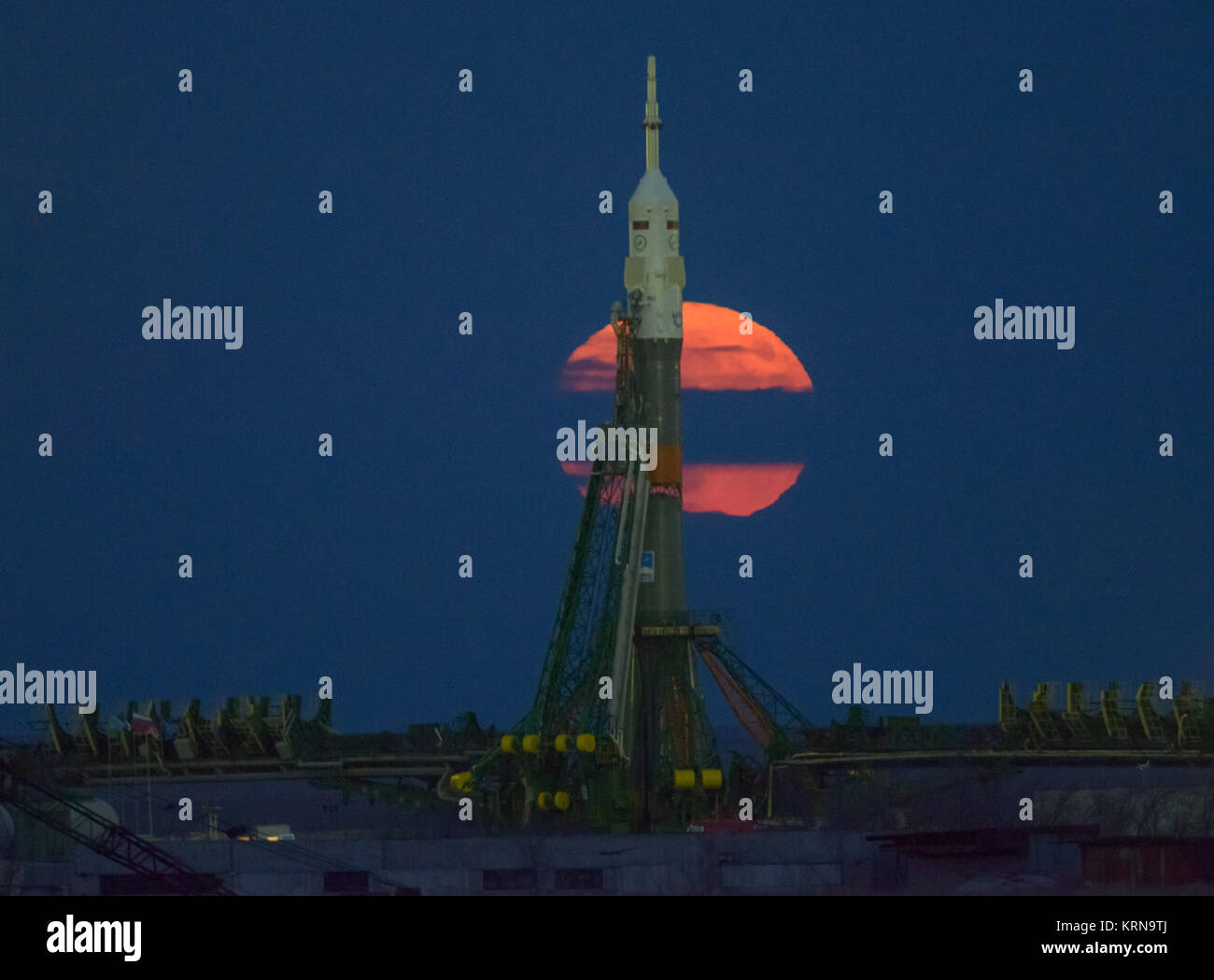 The Moon Or Supermoon Is Seen Rising Behind The Soyuz Rocket At The