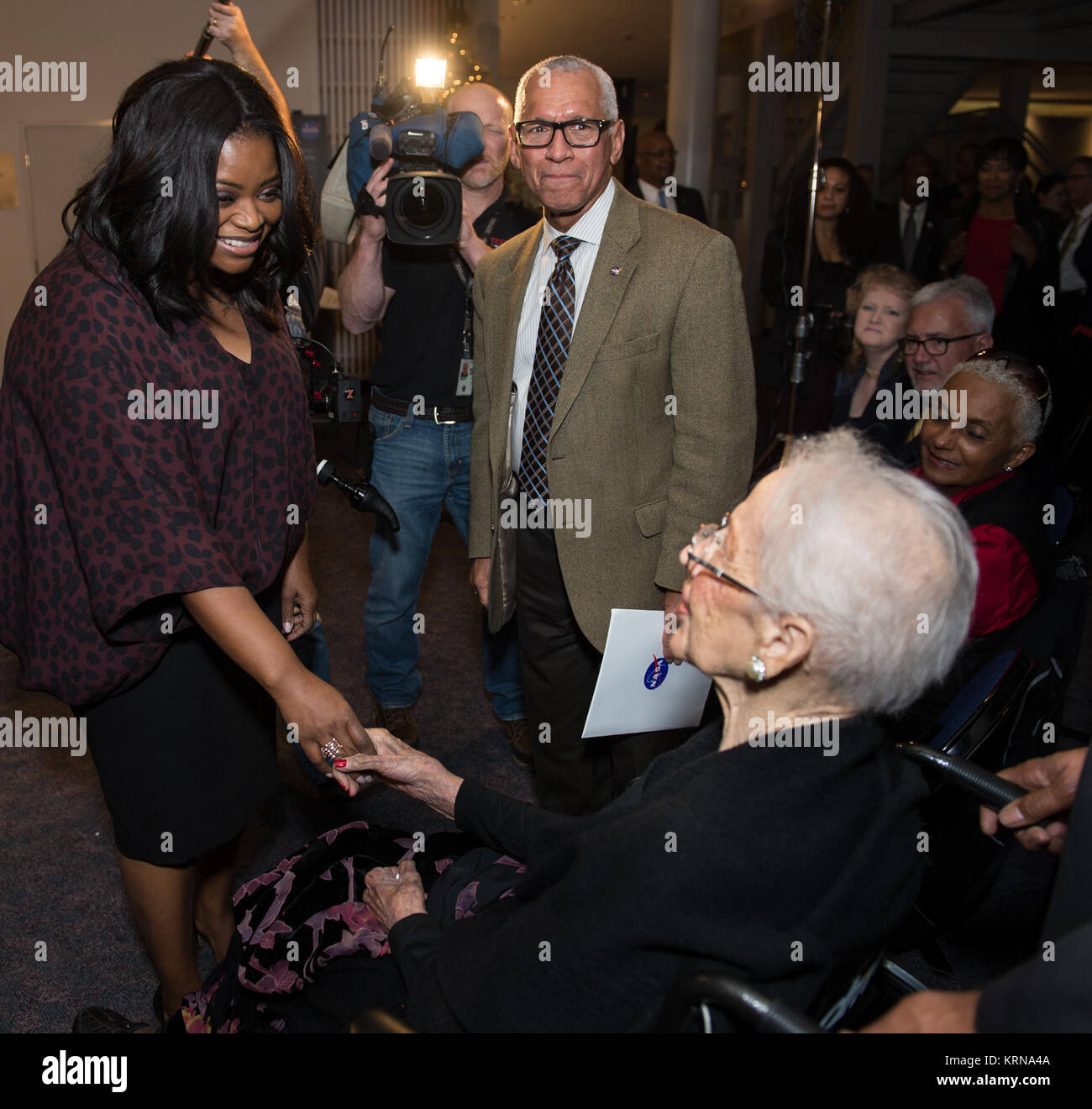 Actress Octavia Spencer, left, who plays Dorothy Vaughan in the film "Hidden Figures" and NASA Administrator Charles Bolden, right, greets NASA "human computer" Katherine Johnson, at a reception to honor NASA's "human computers" on Thursday, Dec. 1, 2016, at the Virginia Air and Space Center in Hampton, VA. Afterward, the guests attended a premiere of "Hidden Figures" a film which stars Taraji P. Henson as Katherine Johnson, the African American mathematician, physicist, and space scientist, who calculated flight trajectories for John Glenn's first orbital flight in 1962. Photo Credit: (NASA/A Stock Photo