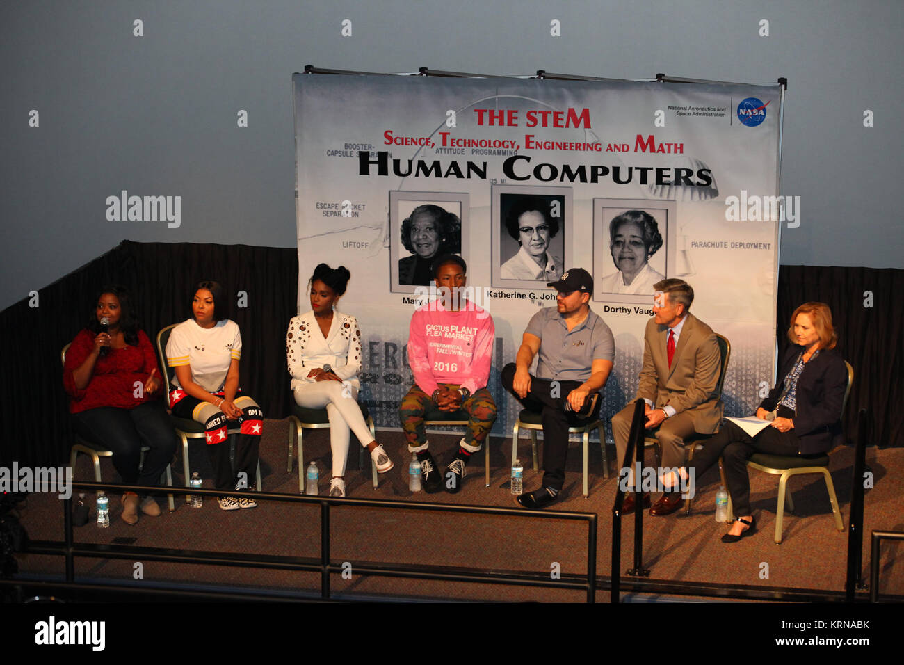 In the IMAX Theater of the Kennedy Space Center Visitor Complex Cast and crew members of the upcoming motion picture 'Hidden Figures' participate in a question and answer session. From the left are Octavia Spencer, who portrays Dorothy Vaughan in the film, Taraji P. Henson, who portrays Katherine Johnson, Janelle Monáe, who portrays Mary Jackson, Pharrell Williams, musician and producer of “Hidden Figures,' Ted Melfi, writer and director of “Hidden Figures,” center director Bob Cabana, and Janet Petro, deputy center director. The movie is based on the book of the same title, by Margot Lee Shet Stock Photo