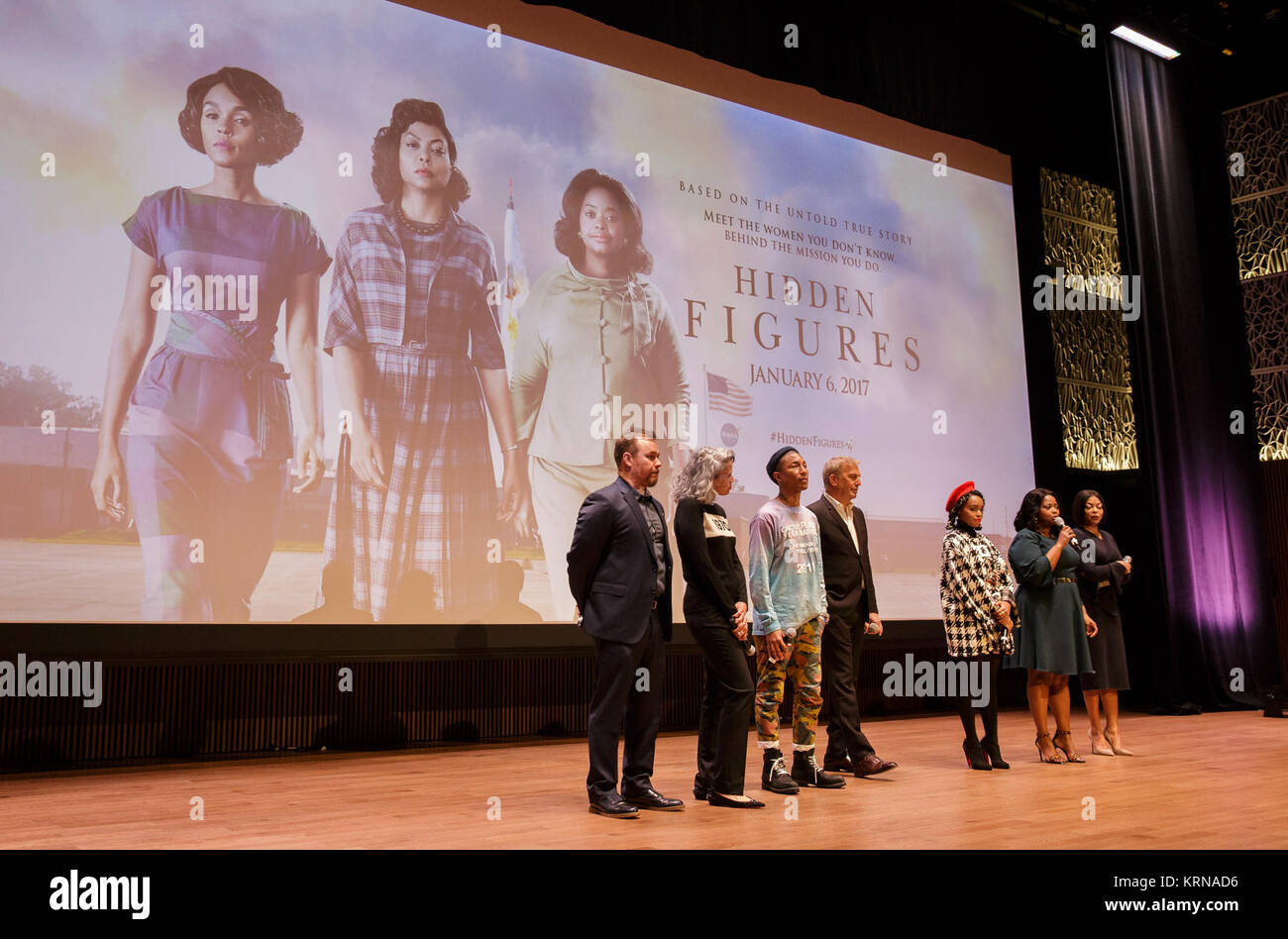 From left: director Theodore Melfi, producer Mimi Valdés,  American singer-songwriter Pharrell Williams, American actor, film director, and producer Kevin Costner, American musical recording artist, actress, and model Janelle Monáe, American actress Octavia Spencer, and American actress and singer Taraji P. Henson, are seen on stage prior to a screening of the film “Hidden Figures” at the Smithsonian’s National Museum of African American History and Culture, Wednesday, Dec. 14, 2016 in Washington DC. The film is based on the book of the same title, by Margot Lee Shetterly, and chronicles the l Stock Photo