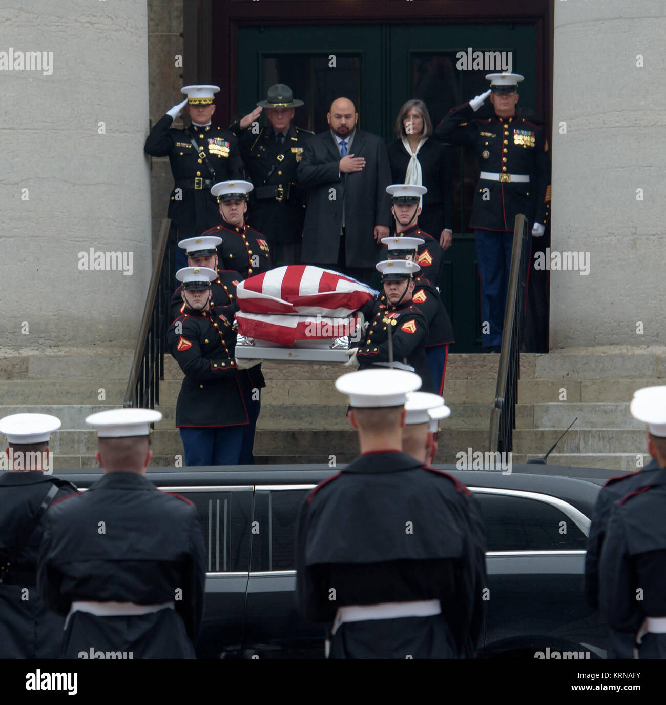 Speaker of the Ohio House Clifford Rosenberger, top center, puts his hand over his heart as former astronaut and U.S. Senator John Glenn's funeral procession is lead out of the Ohio Statehouse in Columbus, Ohio, Saturday, December 17, 2016.  Photo Credit: (NASA/Bridget Caswell) John Glenn Procession (NHQ201612170016) Stock Photo