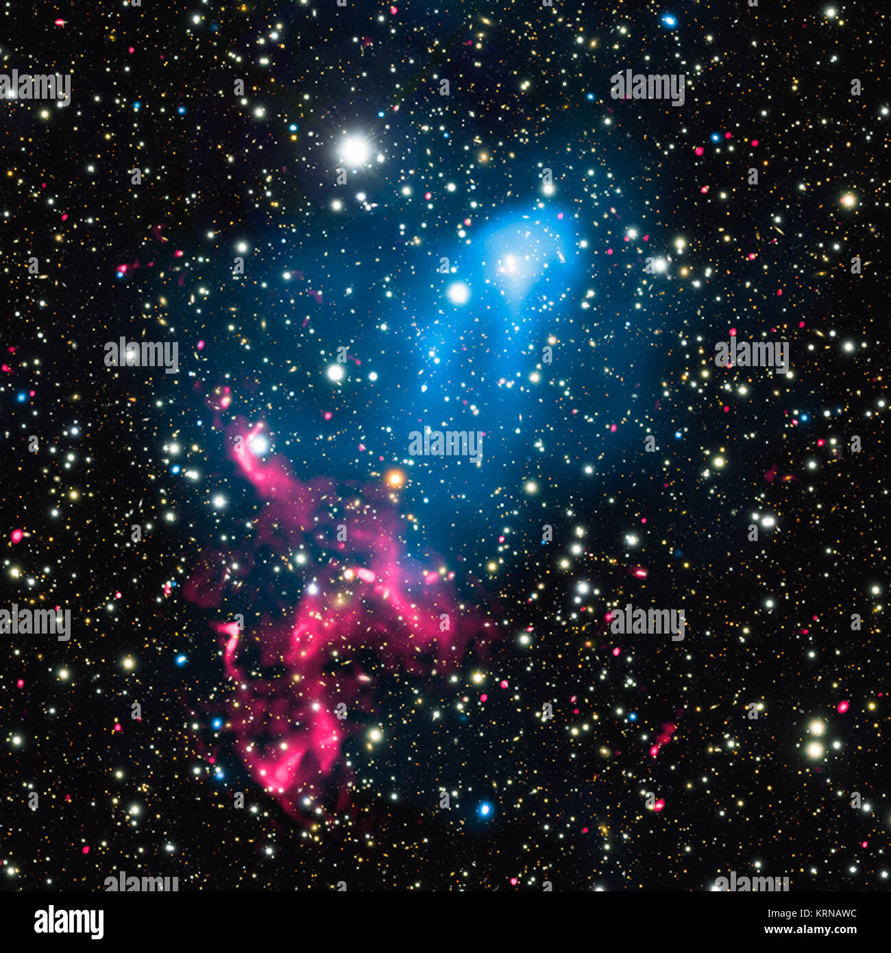 Astronomers have discovered what happens when the eruption from a supermassive black hole is swept up by the collision and merger of two galaxy clusters. This composite image contains X-rays from Chandra (blue), radio emission from the GMRT (red), and optical data from Subaru (red, green, and blue) of the colliding galaxy clusters called Abell 3411 and Abell 3412. These and other telescopes were used to analyze how the combination of these two powerful phenomena can create an extraordinary cosmic particle accelerator. A3411 Stock Photo