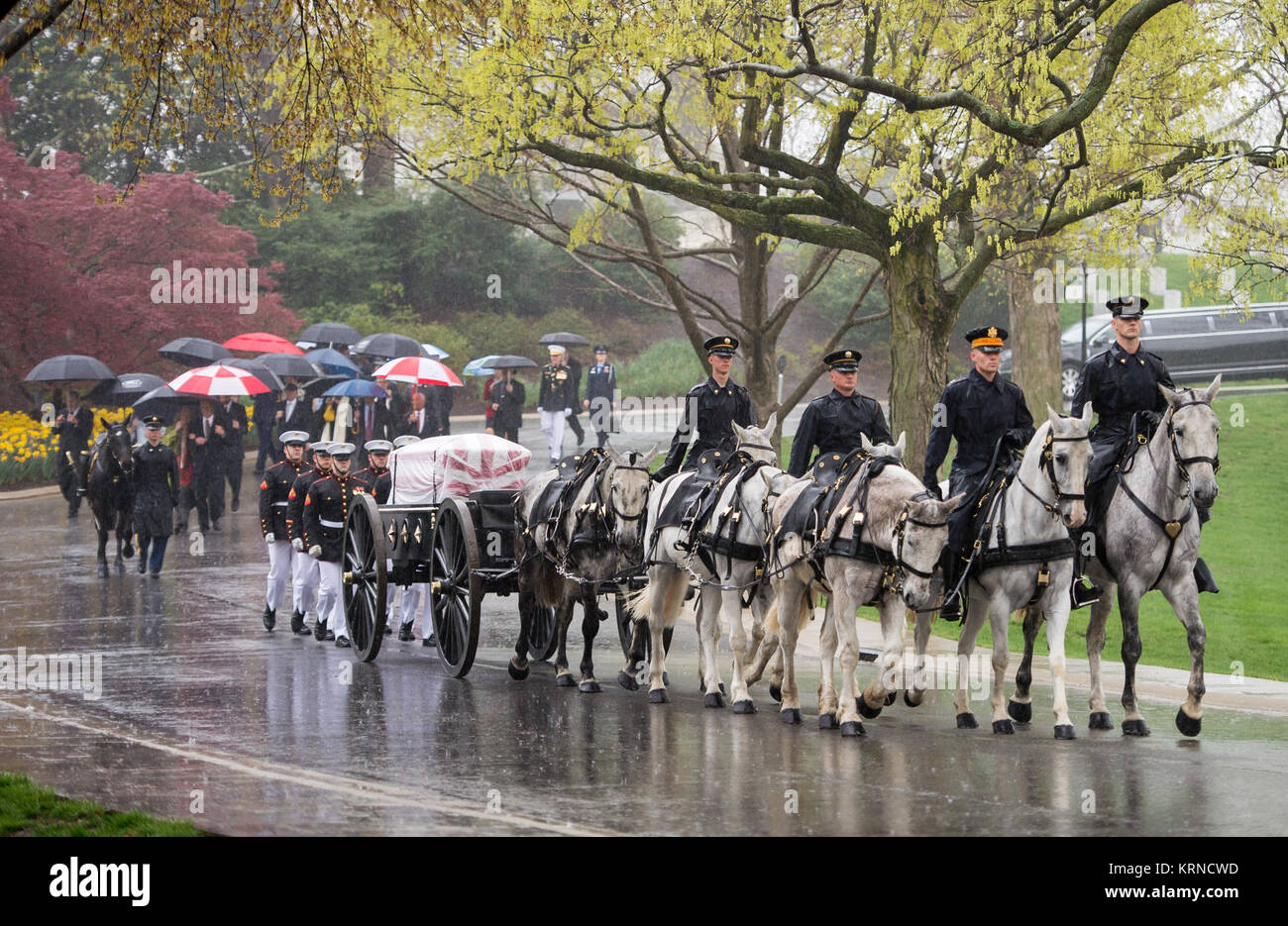 A horse drawn caisson carries former astronaut and U.S. Senator John Glenn to his final resting place during the interment ceremony at Arlington National Cemetery on Thursday, April 6, 2017 in Virginia. Glenn was the first American to orbit Earth on Feb. 20, 1962, in a five-hour flight aboard the Friendship 7 spacecraft. In 1998, he broke another record by returning to space at the age of 77 on the Space Shuttle Discovery. Photo Credit: (NASA/Aubrey Gemignani) John Glenn Interment (NHQ201704060001) Stock Photo