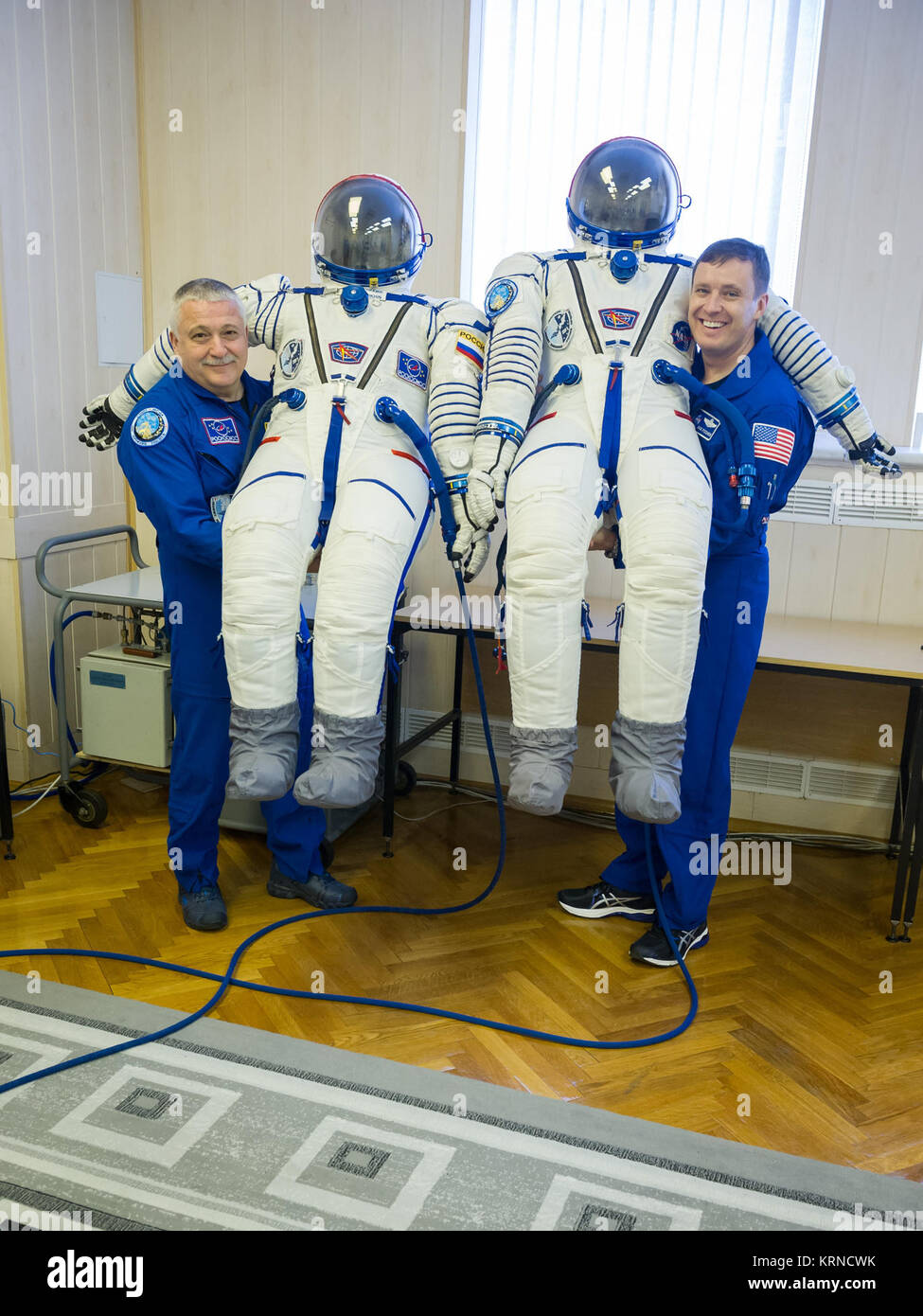 12-42-38:  In the Integration Building at the Baikonur Cosmodrome in Kazakhstan, Expedition 51 crewmembers Fyodor Yurchikhin of the Russian Federal Space Agency (Roscosmos, left) and Jack Fischer of NASA (right) pose for pictures April 6 with their Russian Sokol launch and entry suits as part of pre-launch training preparations. Fischer and Yurchikhin will launch April 20 on the Soyuz MS-04 spacecraft for a four and a half month mission on the International Space Station.  NASA/Gagarin Cosmonaut Training Center/Andrey Shelepin Soyuz MS-04 crew members with their space suits Stock Photo