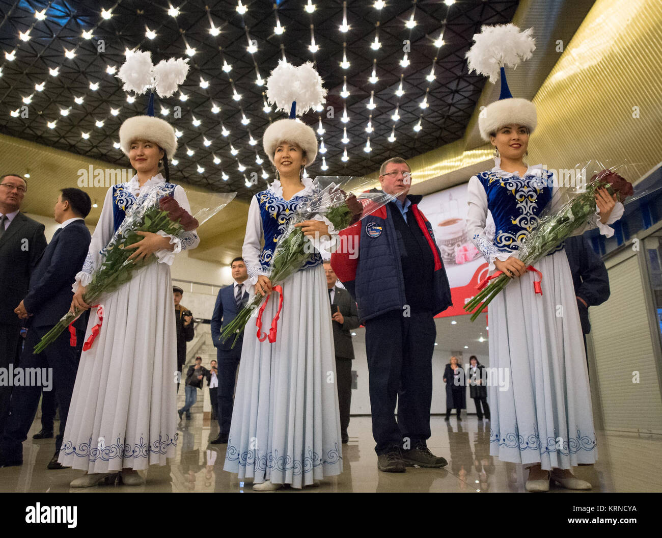 Girls in traditional Kazakhstan dress wait to welcome the return of Expedition 50 Commander Shane Kimbrough of NASA and Flight Engineers Sergey Ryzhikov and Andrey Borisenko of Roscosmos at a Karaganda Airport welcome ceremony in Kazakhstan on Monday, April 10, 2017. 2017 (Kazakh time). Kimbrough, Ryzhikov, and Borisenko are returning after 173 days in space where they served as members of the Expedition 49 and 50 crews onboard the International Space Station. Photo Credit: (NASA/Bill Ingalls) Expedition 50 Soyuz MS-02 Landing (NHQ201704100049) Stock Photo