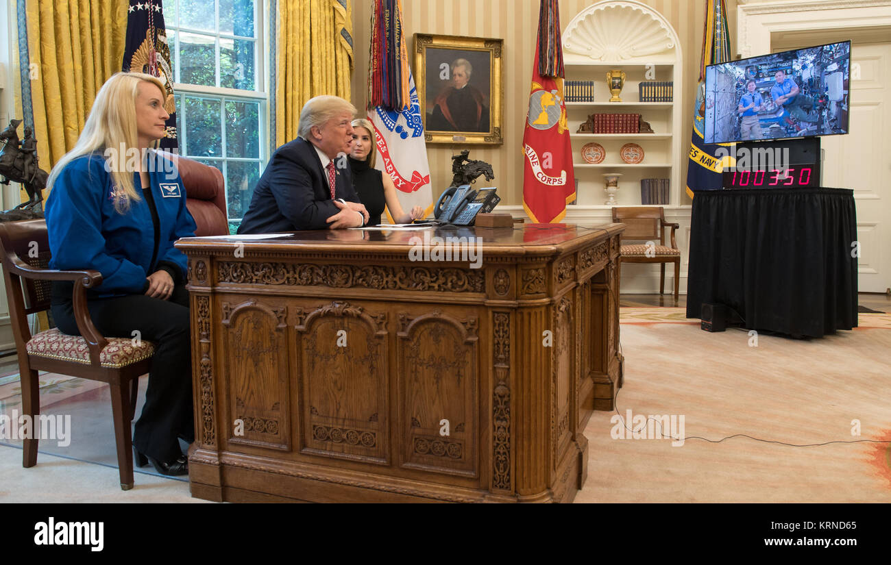 President Donald Trump, joined by NASA astronaut Kate Rubins, left, and First Daughter Ivanka Trump, talks with NASA astronauts Peggy Whitson and Jack Fischer onboard the International Space Station Monday, April 24, 2017 from the Oval Office of the White House in Washington. The President congratulated Whitson for breaking the record for cumulative time spent in space by a U.S. astronaut. The President and First Daughter also discussed with the three astronauts what it is like to live and work on the orbiting outpost as well as the importance of STEM.  Photo Credit: (NASA/Bill Ingalls) Earth- Stock Photo