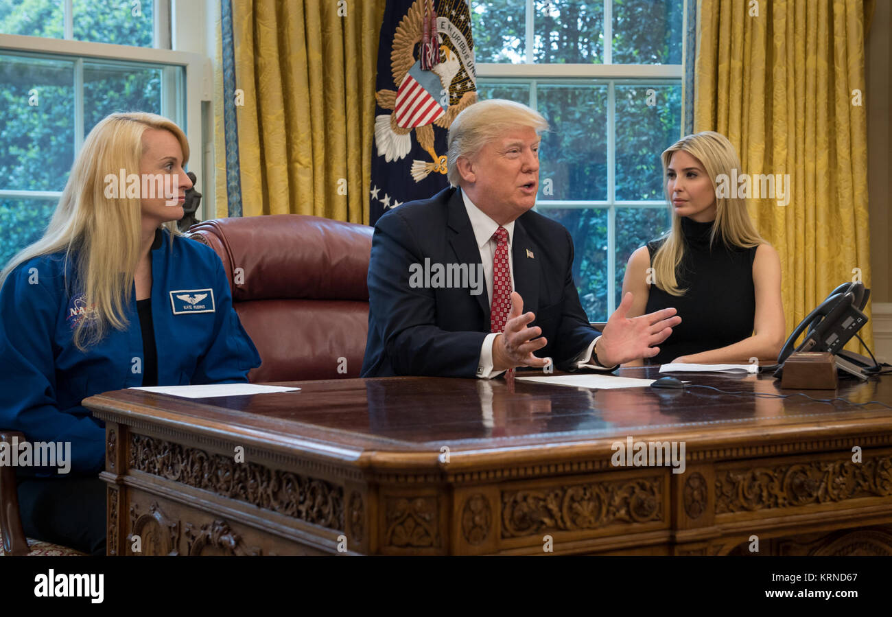 President Donald Trump, joined by NASA astronaut Kate Rubins, left, and First Daughter Ivanka Trump, talks with NASA astronauts Peggy Whitson and Jack Fischer onboard the International Space Station Monday, April 24, 2017 from the Oval Office of the White House in Washington. The President congratulated Whitson for breaking the record for cumulative time spent in space by a U.S. astronaut. The President and First Daughter also discussed with the three astronauts what it is like to live and work on the orbiting outpost as well as the importance of STEM.  Photo Credit: (NASA/Bill Ingalls) Earth- Stock Photo