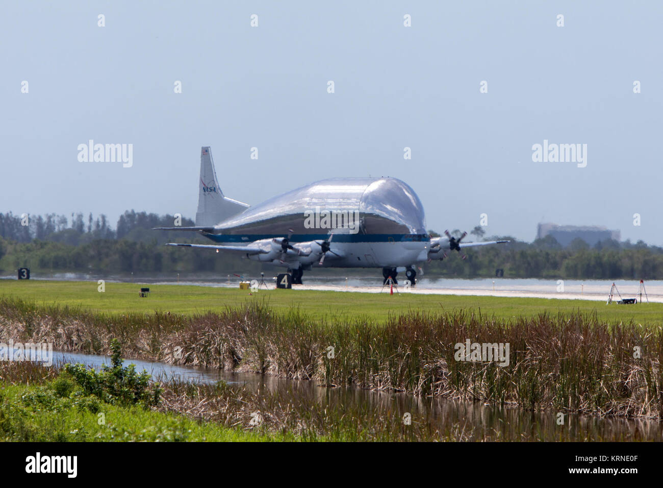 NASA's Super Guppy aircraft touches down at the Shuttle Landing Facility, managed and operated by Space Florida, at Kennedy Space Center in Florida. The Orion service module structural test article for Exploration Mission-1 (EM-1), built by the European Space Agency, will be loaded into the Guppy for shipment to Lockheed Martin's Denver facility to undergo testing. The Orion spacecraft will launch atop the agency's Space Launch System rocket on EM-1 in 2019. NASA 941 Super Guppy lands to pick up EM-1 Orion Service Module structural test article (KSC-20170623-PH-GEB01 0006) Stock Photo