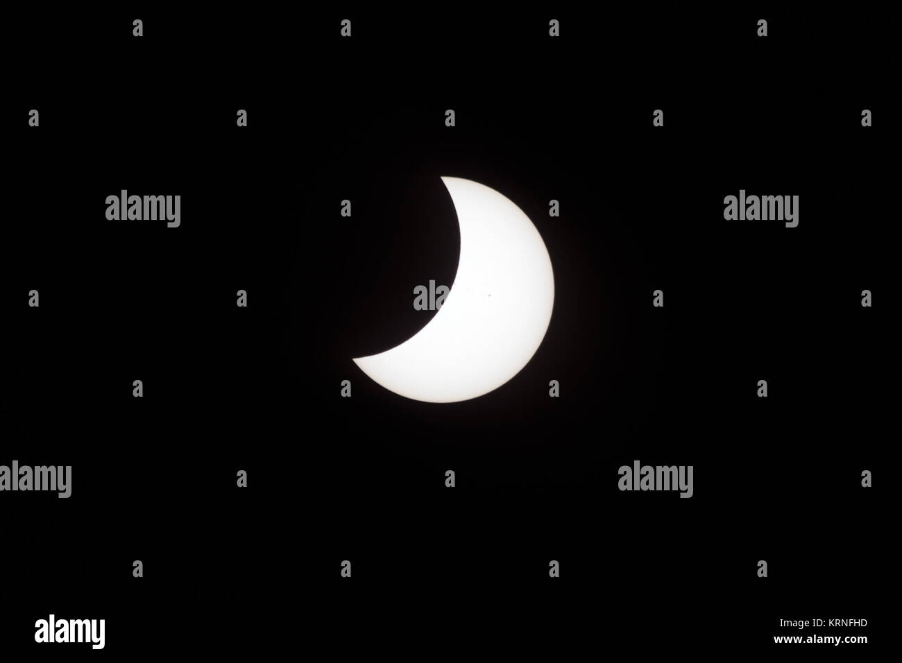 A partial eclipse on Florida's Space Coast, the rare astronomical event was photographed from the top of the Vehicle Assembly Building, as the Moon passed between Earth and the midafternoon Sun. The Moon's shadow moved across the landscape from Oregon to South Carolina. The 70-mile-wide totality path, or 'umbral cone' -- where the entire Sun will vanish behind the Moon -- stretched across 14 states, from Oregon to South Carolina. Partial Eclipse 8-21-17 on KSC 5 Stock Photo