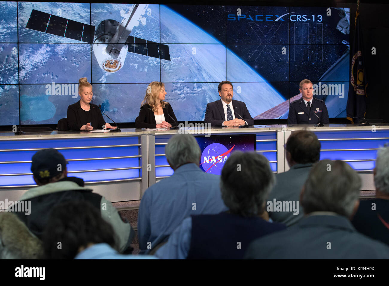 In the Kennedy Space Center’s Press Site auditorium, NASA and industry leaders speak to members of the media during a prelaunch news conference for the SpaceX CRS-13 commercial resupply services mission to the International Space Station. From left are: Cheryl Warner of NASA Communications, Jessica Jensen, SpaceX director of Dragon Mission Management, Kirt Costello, deputy chief scientist for the International Space Station Program Science Office at NASA’s Johnson Space Center in Houston, and Lt. David Myers, weather officer for the 45th Weather Squadron. Kirk Shireman, International Space Sta Stock Photo