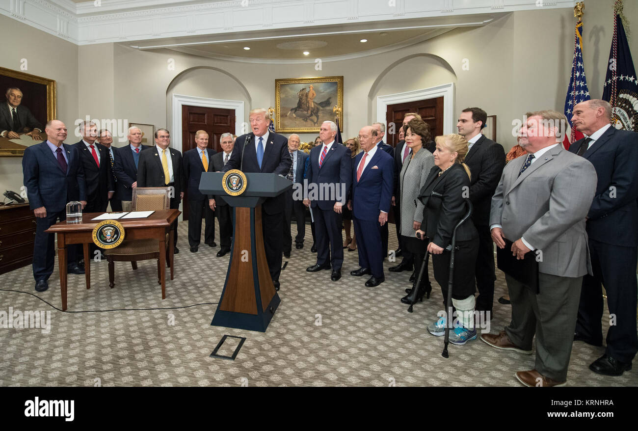 President Donald Trump, speaks before signing the Presidential Space Directive - 1, directing NASA to return to the moon, alongside Vice President Mike Pence, members of the Senate, Congress, NASA, and commercial space companies in the Roosevelt room of the White House in Washington, Monday, Dec. 11, 2017. Photo Credit: (NASA/Aubrey Gemignani) Presidential Space Directive - 1 Signing (NHQ201712110003) Stock Photo
