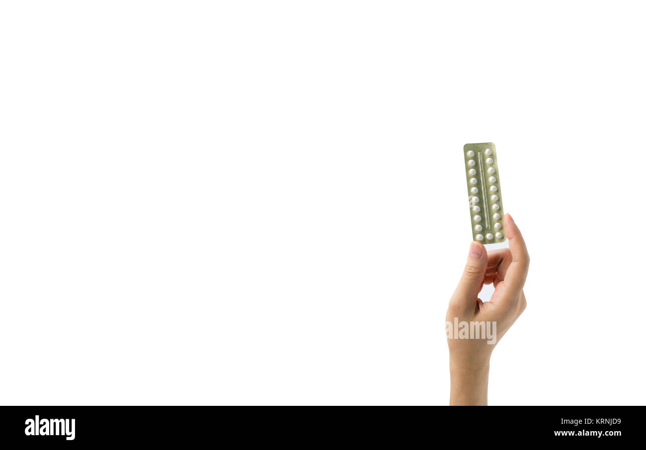 Asian young woman holding pack of contraceptive pills with one hand isolated on white background with copy space and clipping path. Choosing family pl Stock Photo