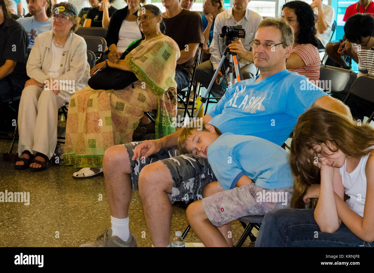 Kids and father sleep during boring talk. Stock Photo