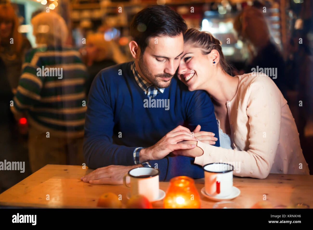 Happy couple talking at bar and having date Stock Photo