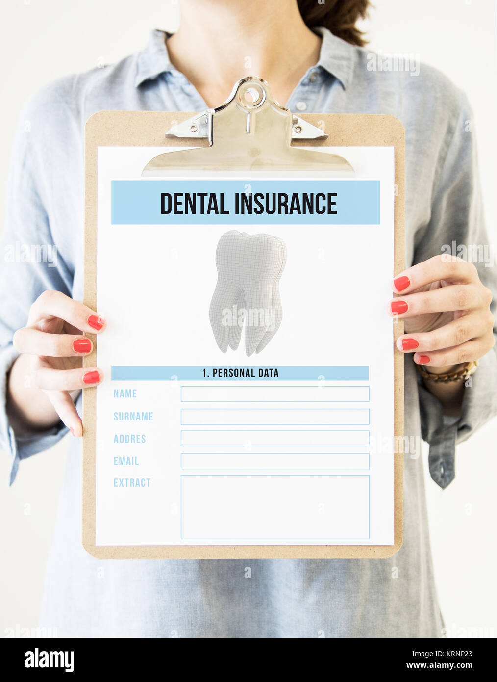 woman holding a clipboard with dental insurance Stock Photo