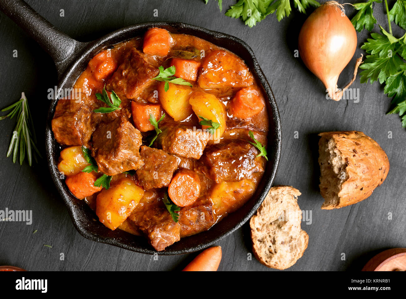Tasty goulash, beef stew in cast iron pan. Top view, flat lay Stock Photo