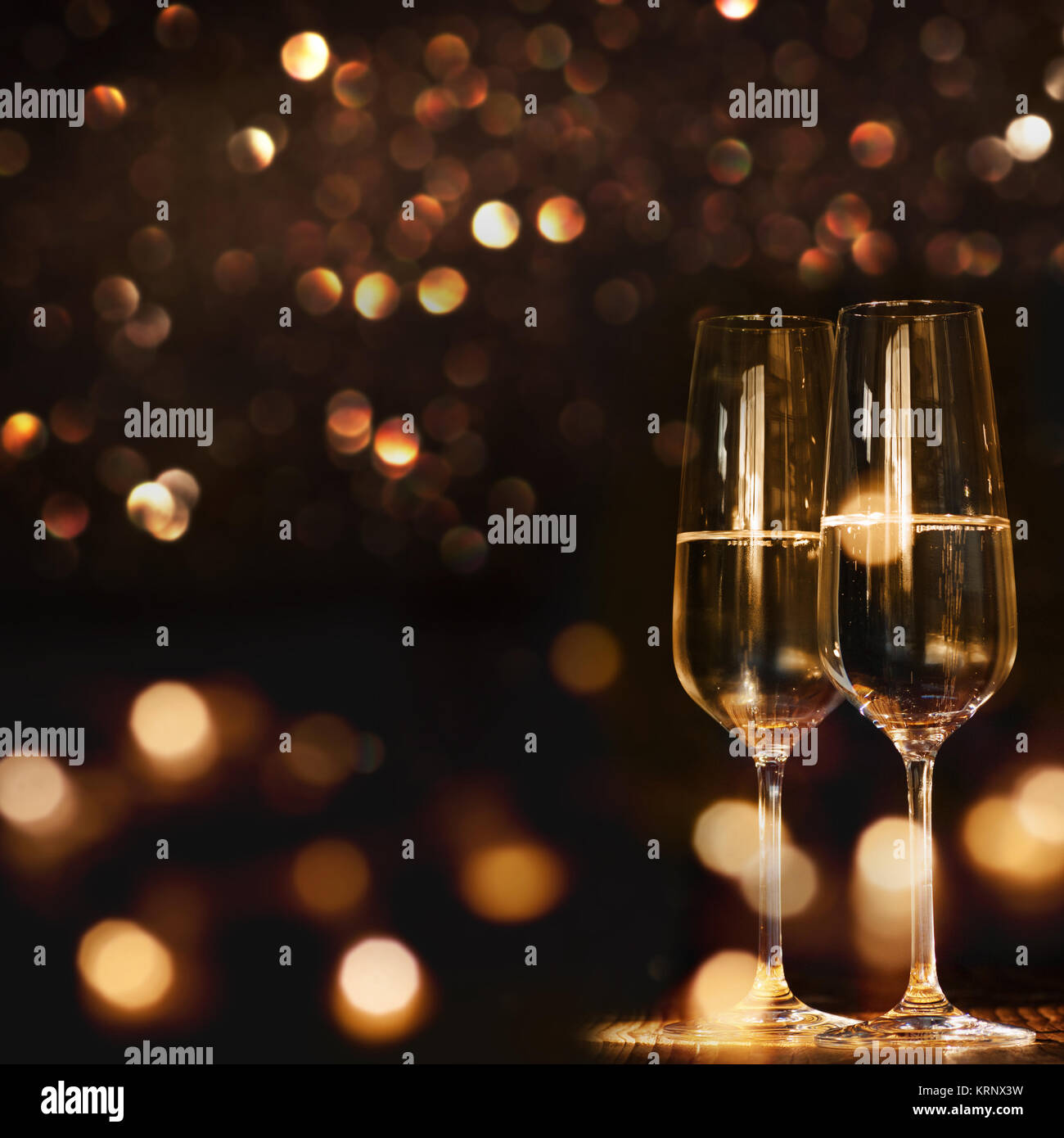 Champagne glasses for a new year against a dark background with gold