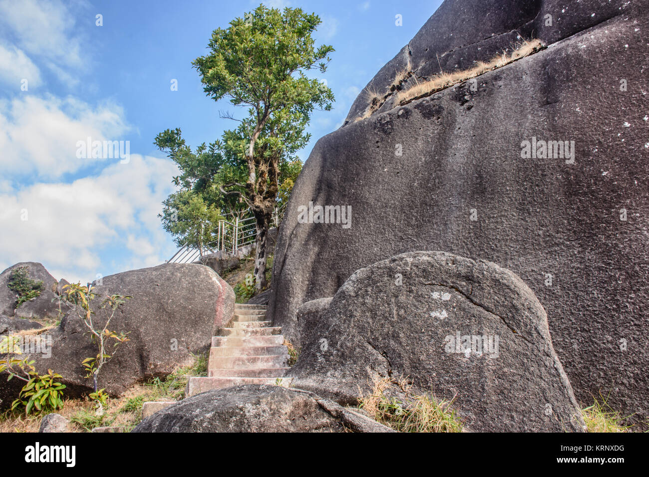 photo of small stairway between huge stone Stock Photo