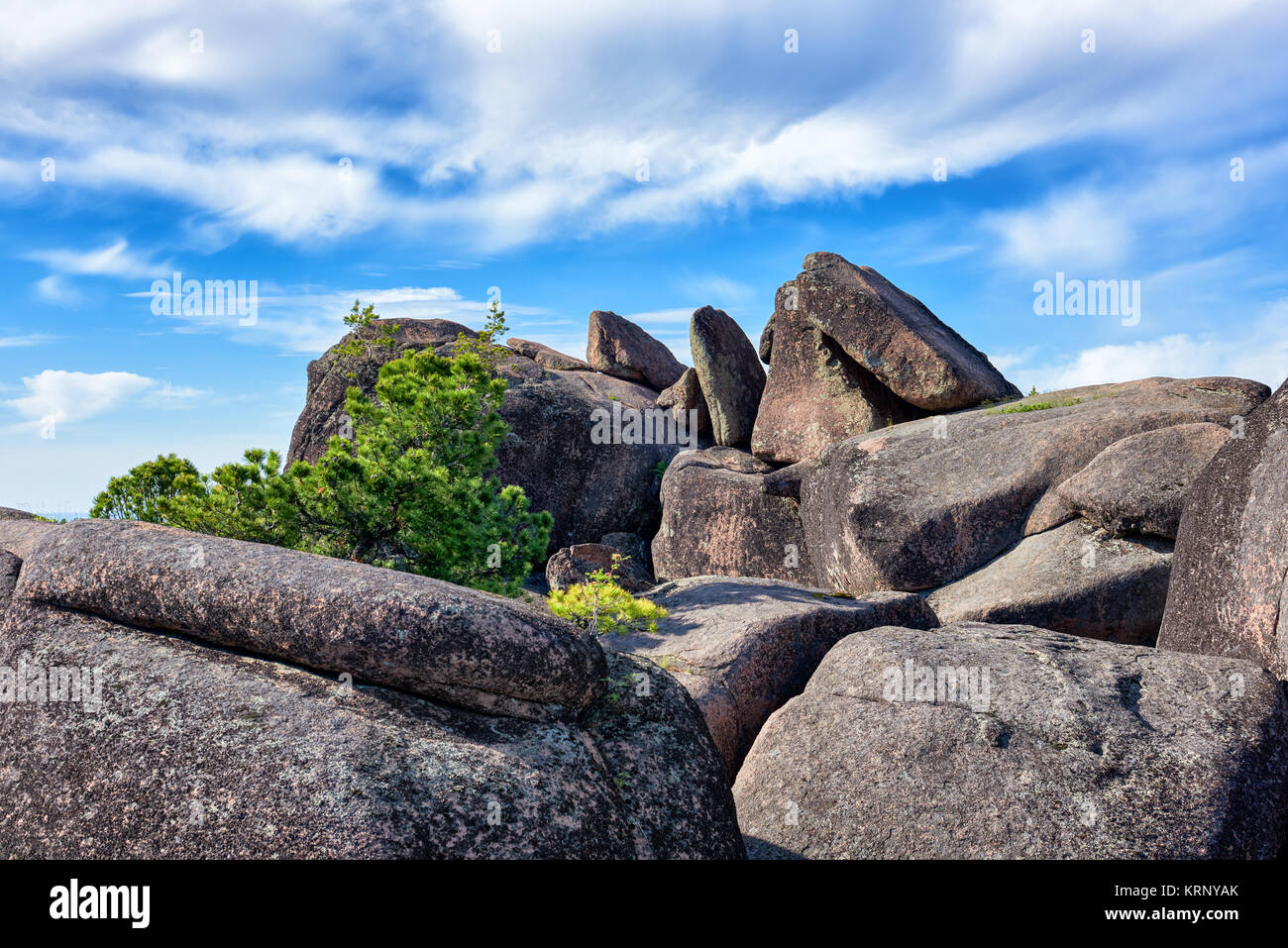Boulders on top of cliff. Stolby Nature Sanctuary (Pillars). Krasnoyarsk region. Russia Stock Photo