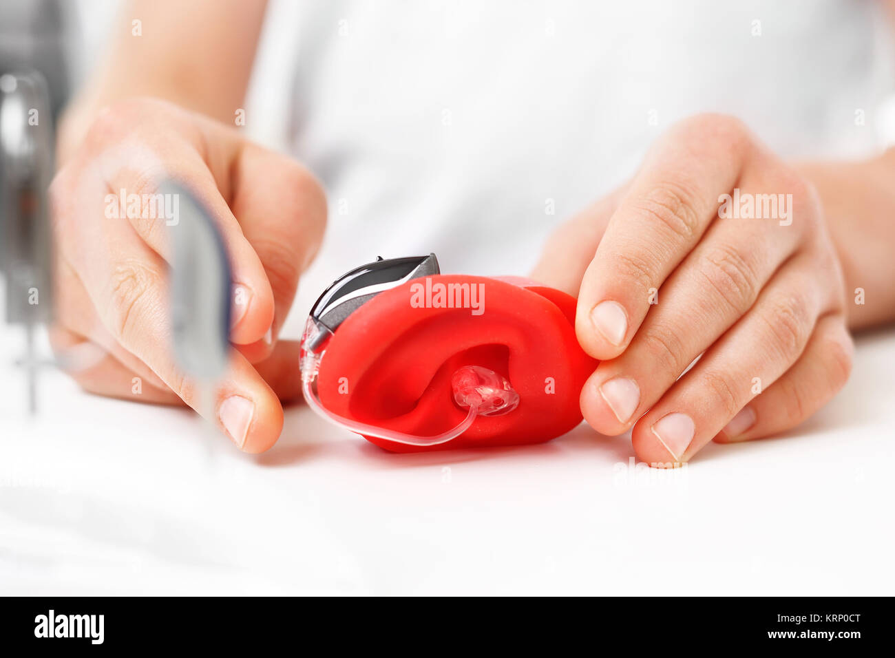 how to wear a hearing aid? Stock Photo
