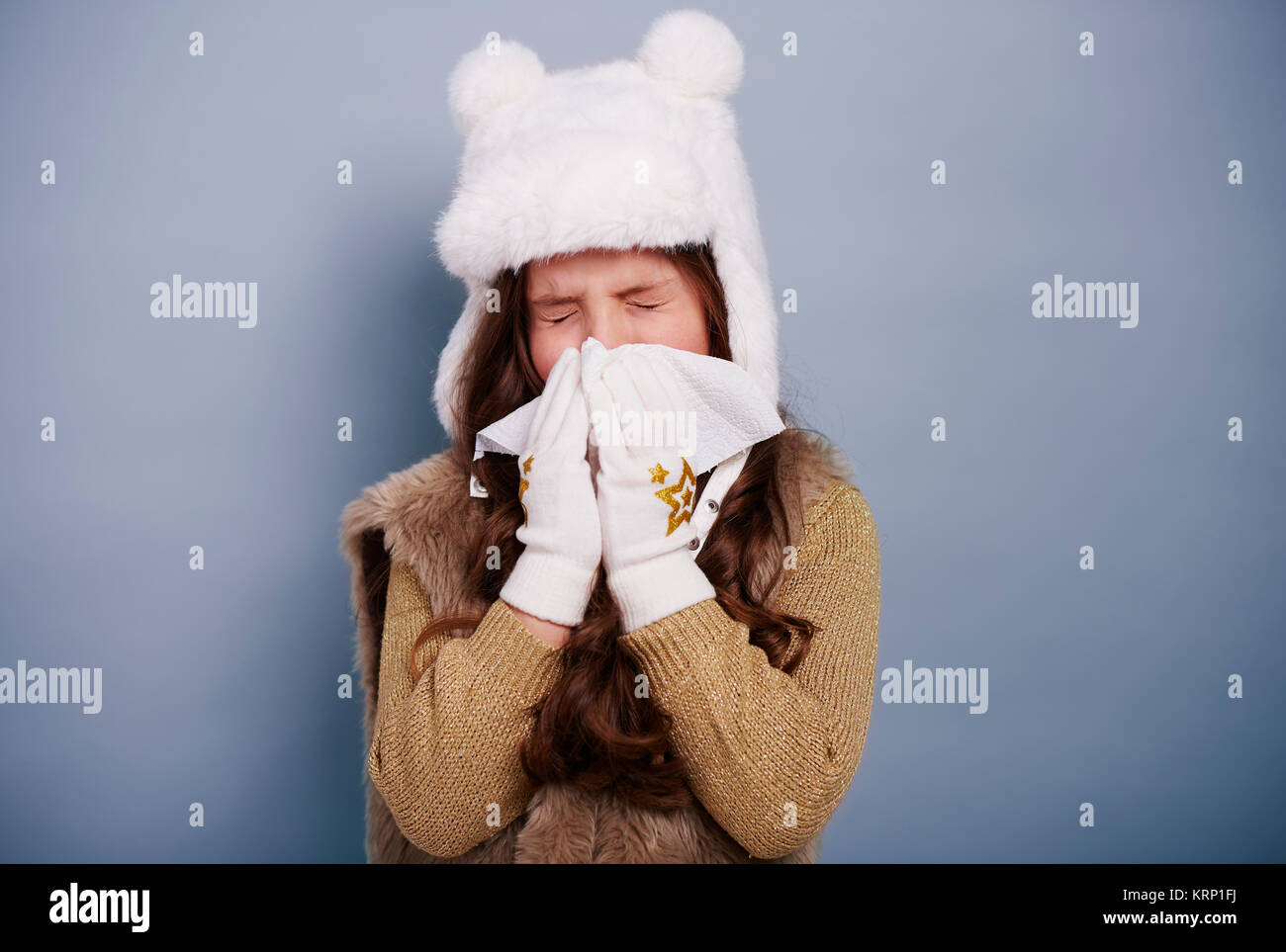 Unhealthy child blowing her nose Stock Photo