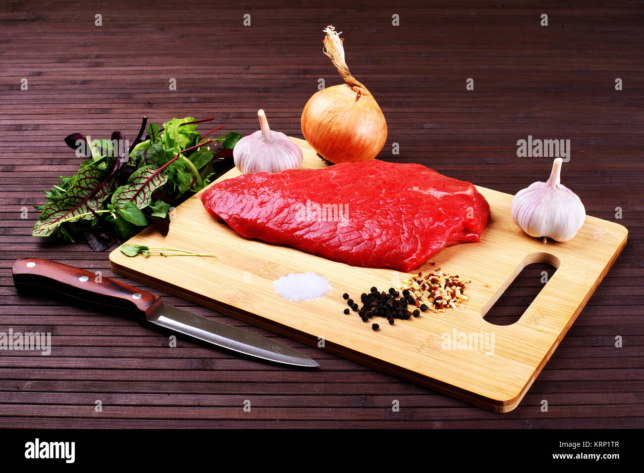 Butcher holding large knife and meat - Stock Image - F006/4436