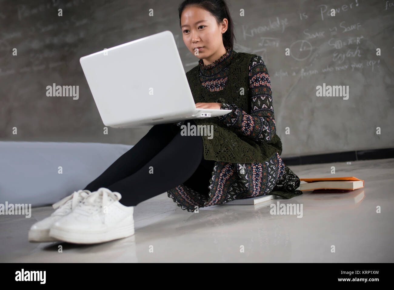 Asia Female college students use laptops.The blackboard to write full formula of the background. Stock Photo