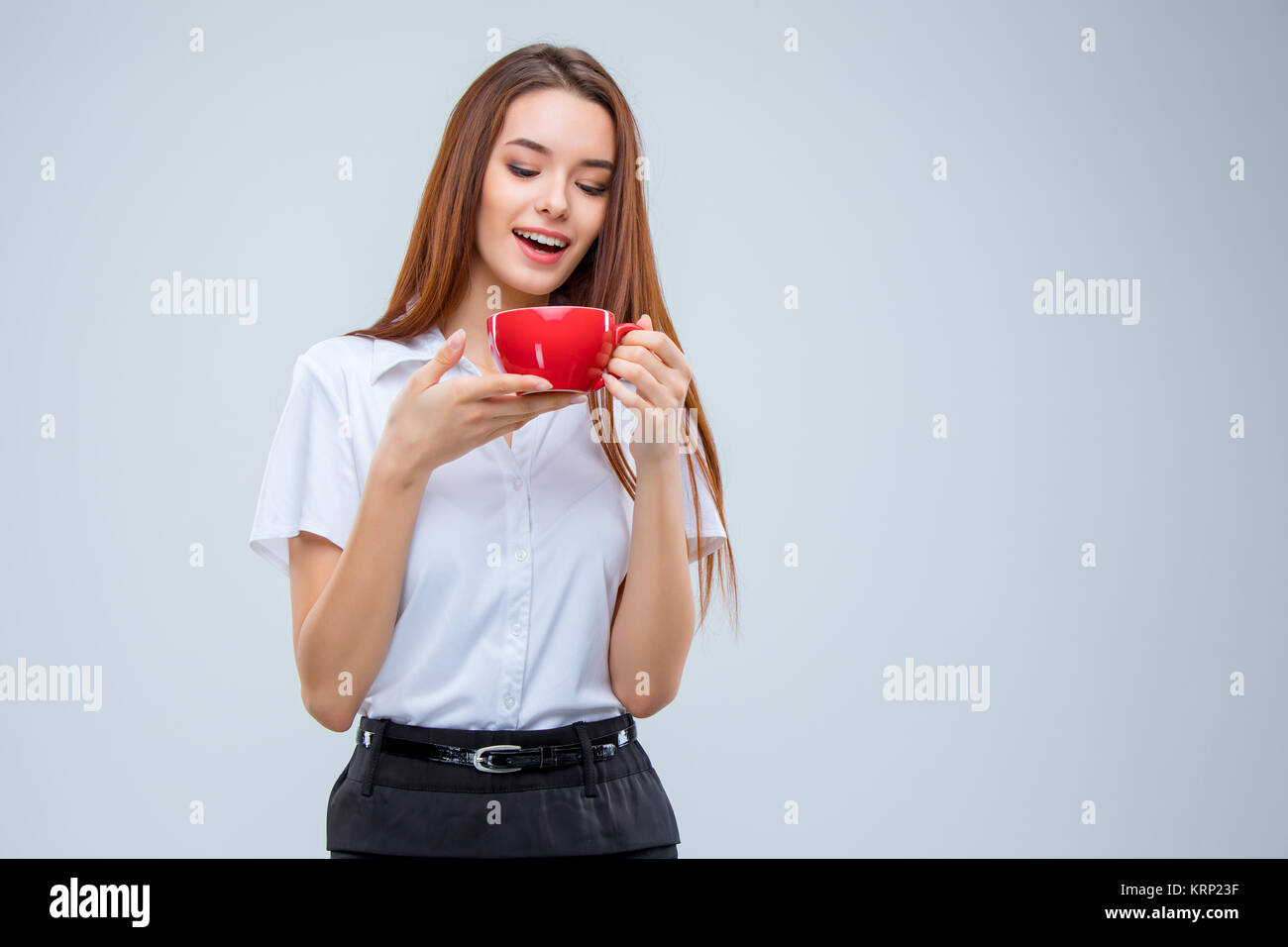 The young business woman on gray background Stock Photo - Alamy