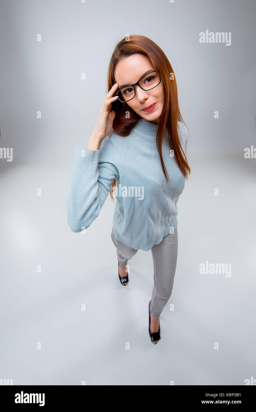 The smiling young business woman on gray background Stock Photo - Alamy