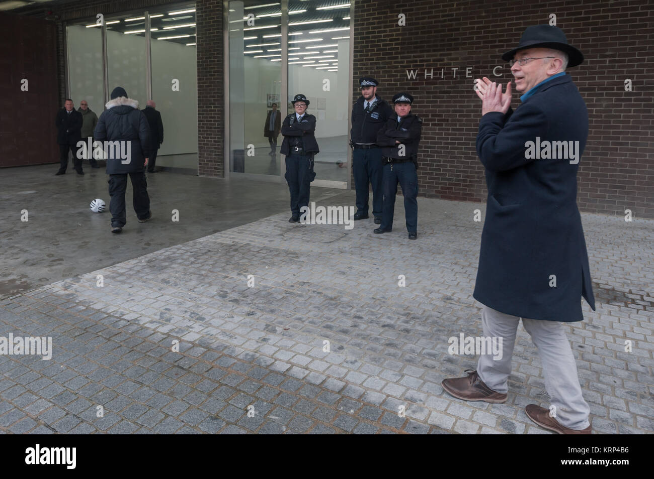 Ian Bone (left) approaches the Bermondsey White Cube Gallery showing Gilbert & George's 'Banners' at the start of the  Class War fottball-themed anti-gentrifcation protest outside Stock Photo