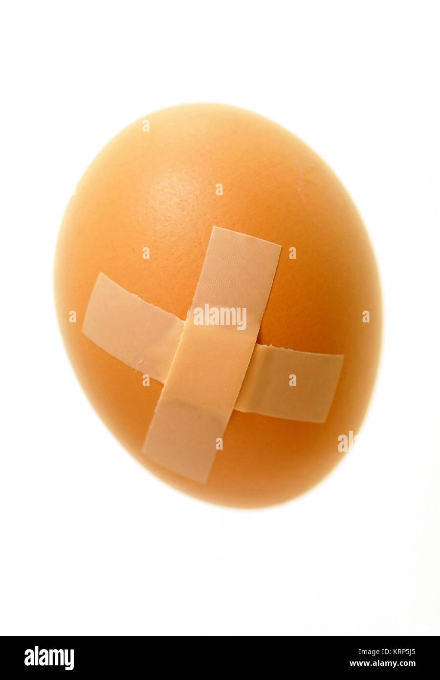 Ei mit Pflaster - egg with plaster Stock Photo