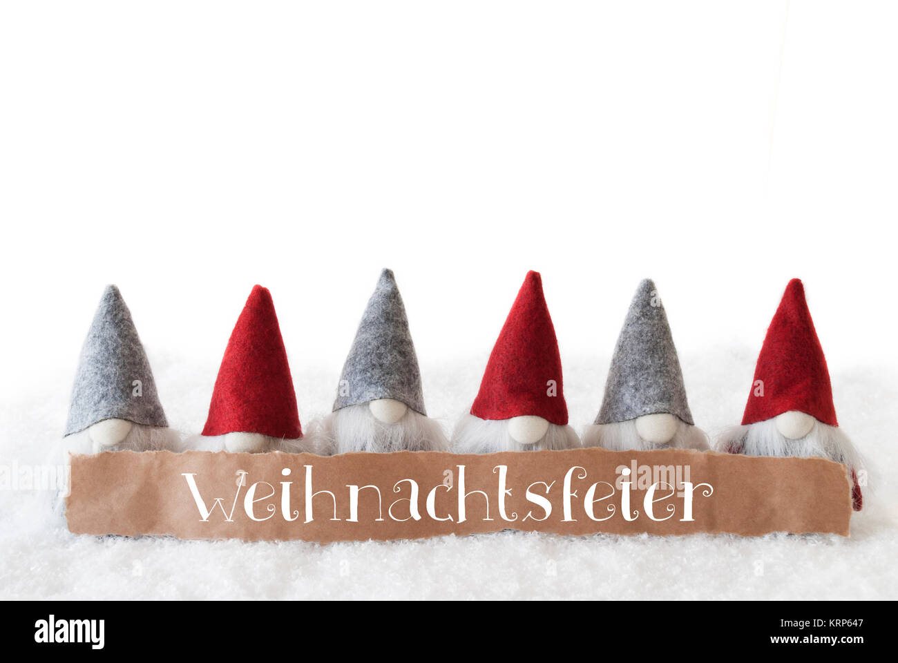 Label With German Text Weihnachtsfeier Means Christmas Party. Christmas Greeting Card With Gnomes. Isolated White Background With Snow. Stock Photo